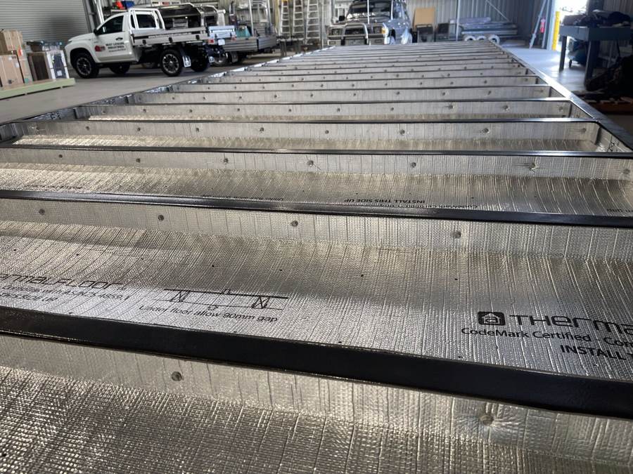 Close-up of code-certified thermal floor insulation being installed